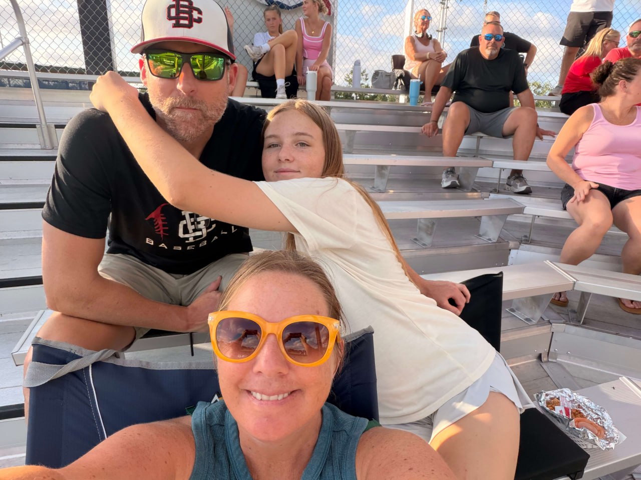 Emily Gibson cheering at a game with family